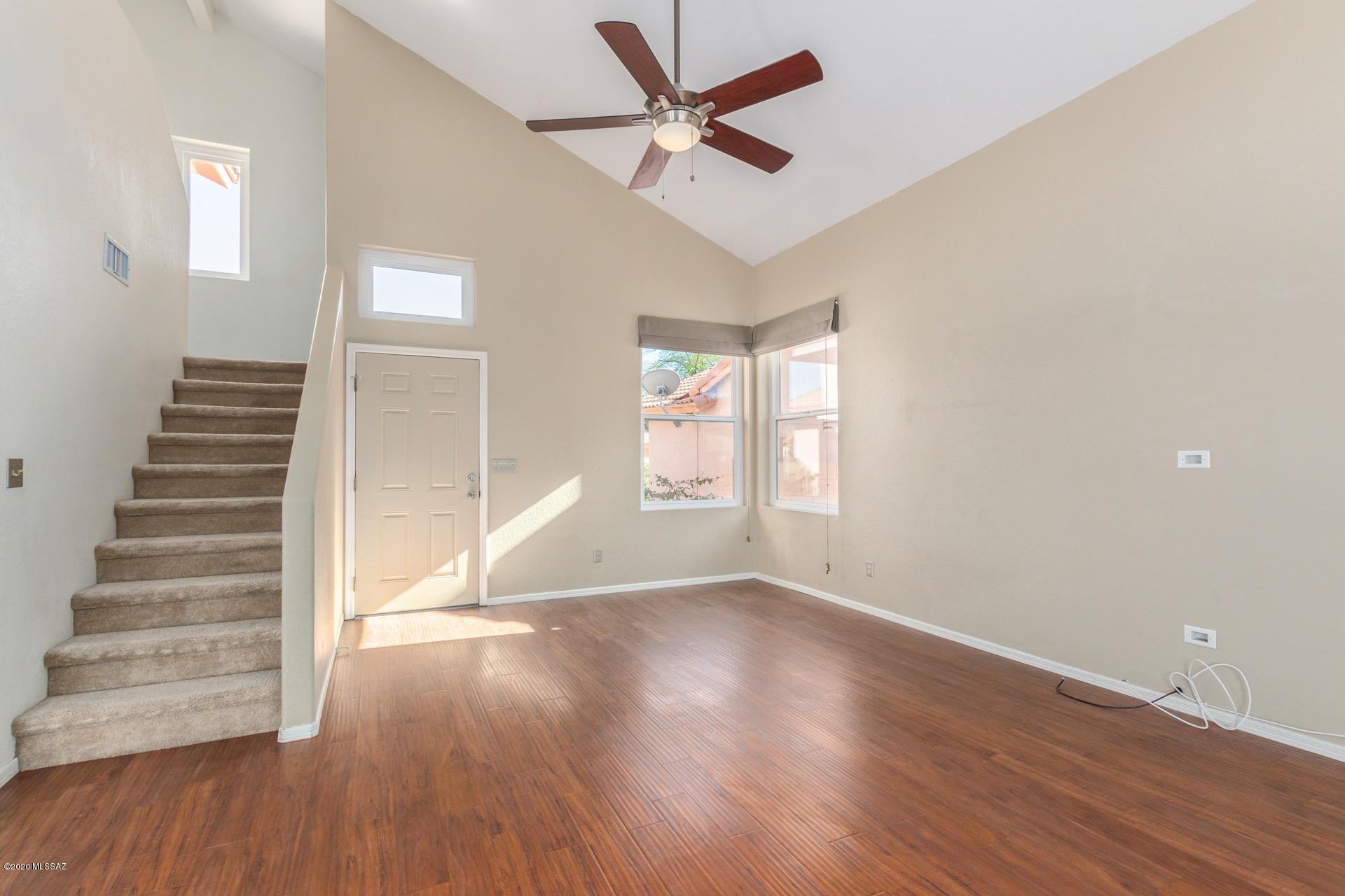 3580 West Sky Ridge Loop Tucson, AZ 85742 - Photo 4 of 29 wooden floor in an empty room with a window