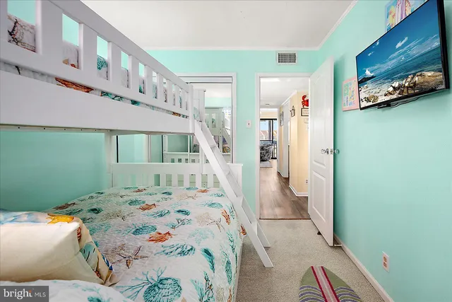 a bedroom with a bed and a tv