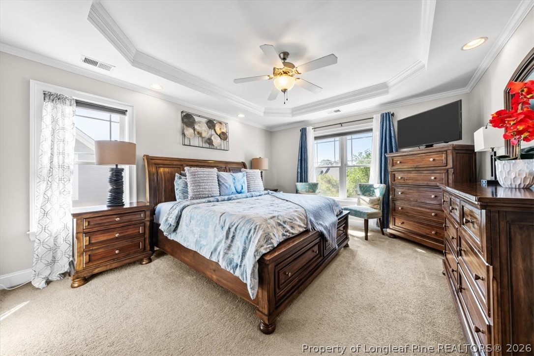 2708 Plum Ridge Road Fayetteville, NC 28306 - Photo 14 of 27 a spacious bedroom with a bed and a chandelier