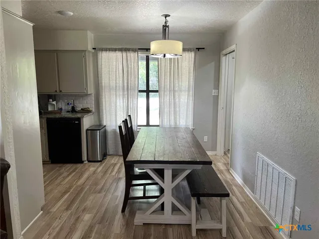 a dining room with furniture and window