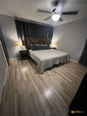 a bedroom with a bed and a chandelier