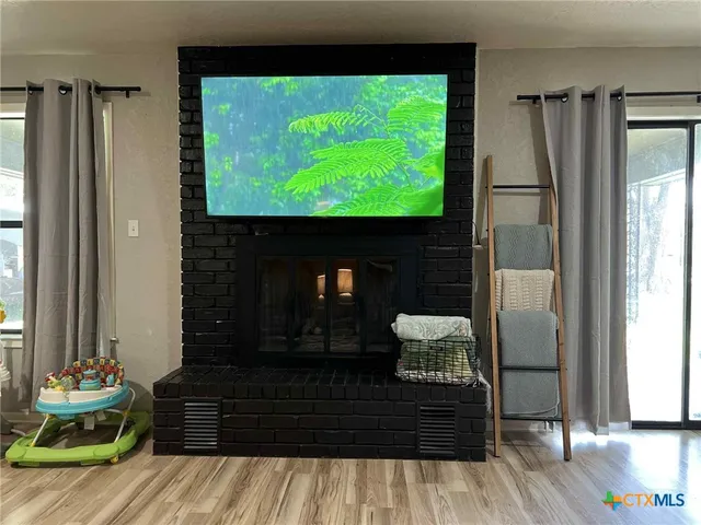 a living room with a bed furniture and a flat screen tv