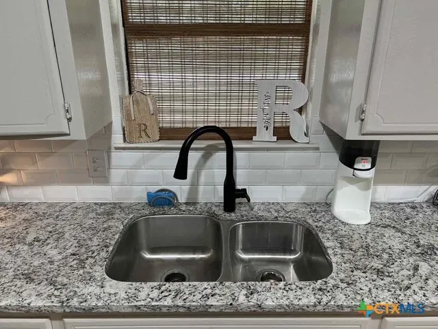 a kitchen with a sink and a window