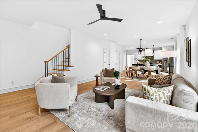 a living room with furniture and a wooden floor
