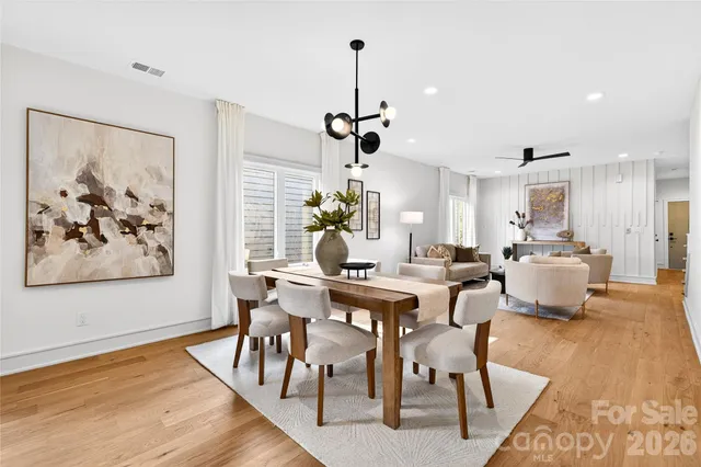 a view of a dining room with furniture wooden floor and a chandelier