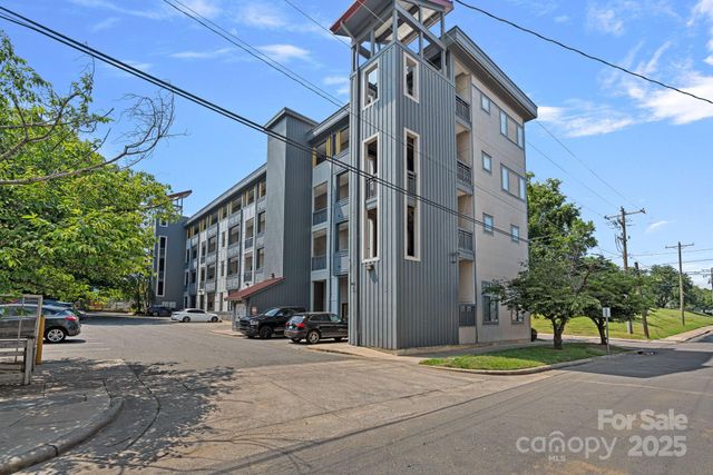 a city street lined with buildings and trees