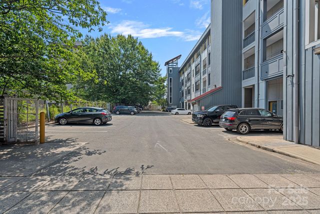 a view of a cars parked on the side of a street