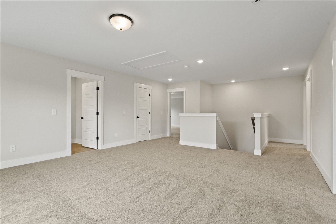 313 Old Shirley Road Central, SC 29630 - Photo 15 of 30 This spacious bonus room features soft carpeted flooring, creating a comfortable and versatile living area.