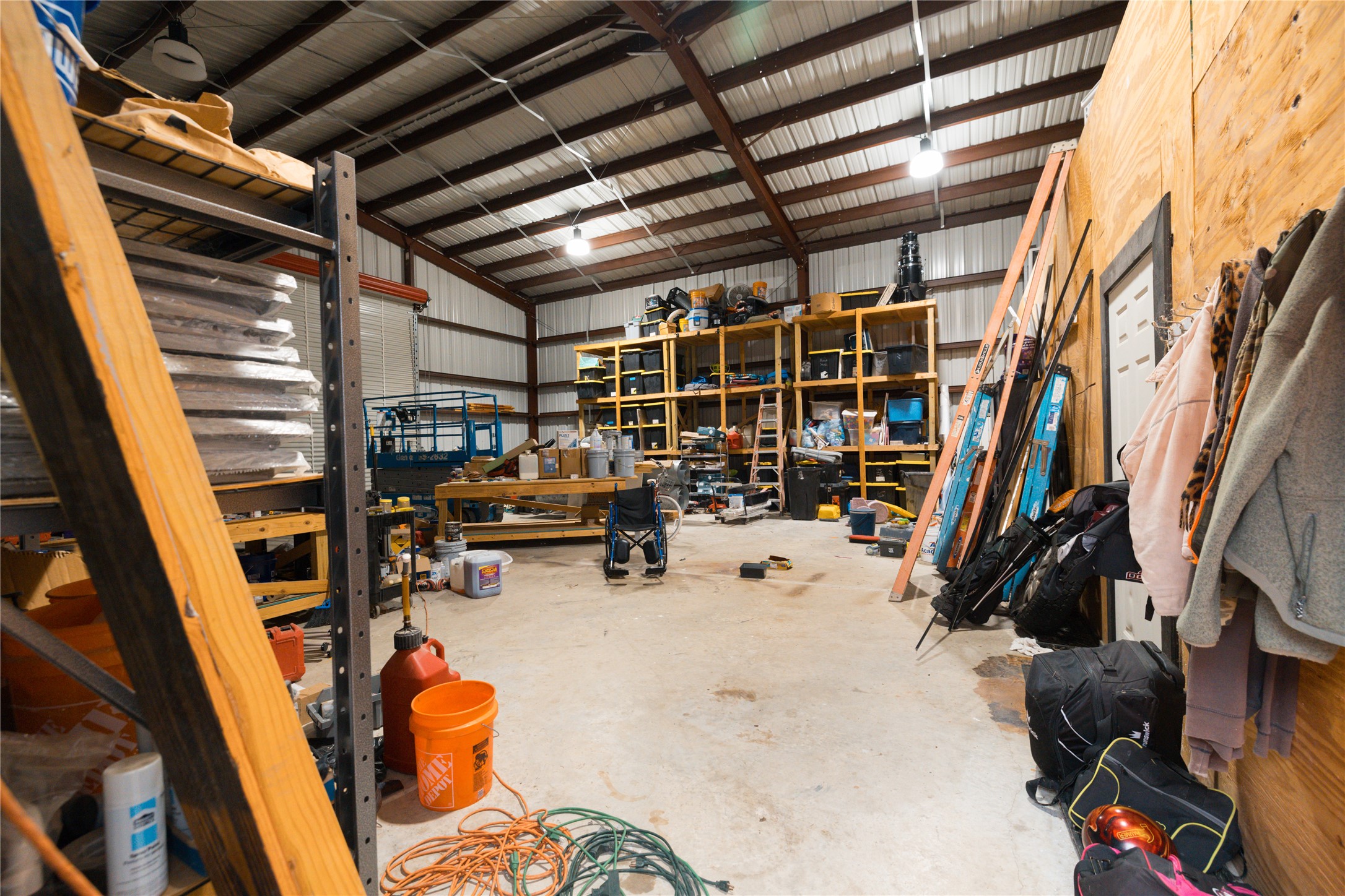 143 County Road Paige, TX 78659 - Photo 29 of 36 Shop/Garage featuring metal wall and a workshop area with lots of storage