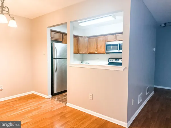 a view of a kitchen with a refrigerator a microwave and a sink