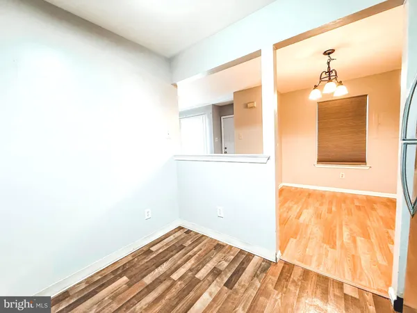 a view of a room with wooden floor and cabinet