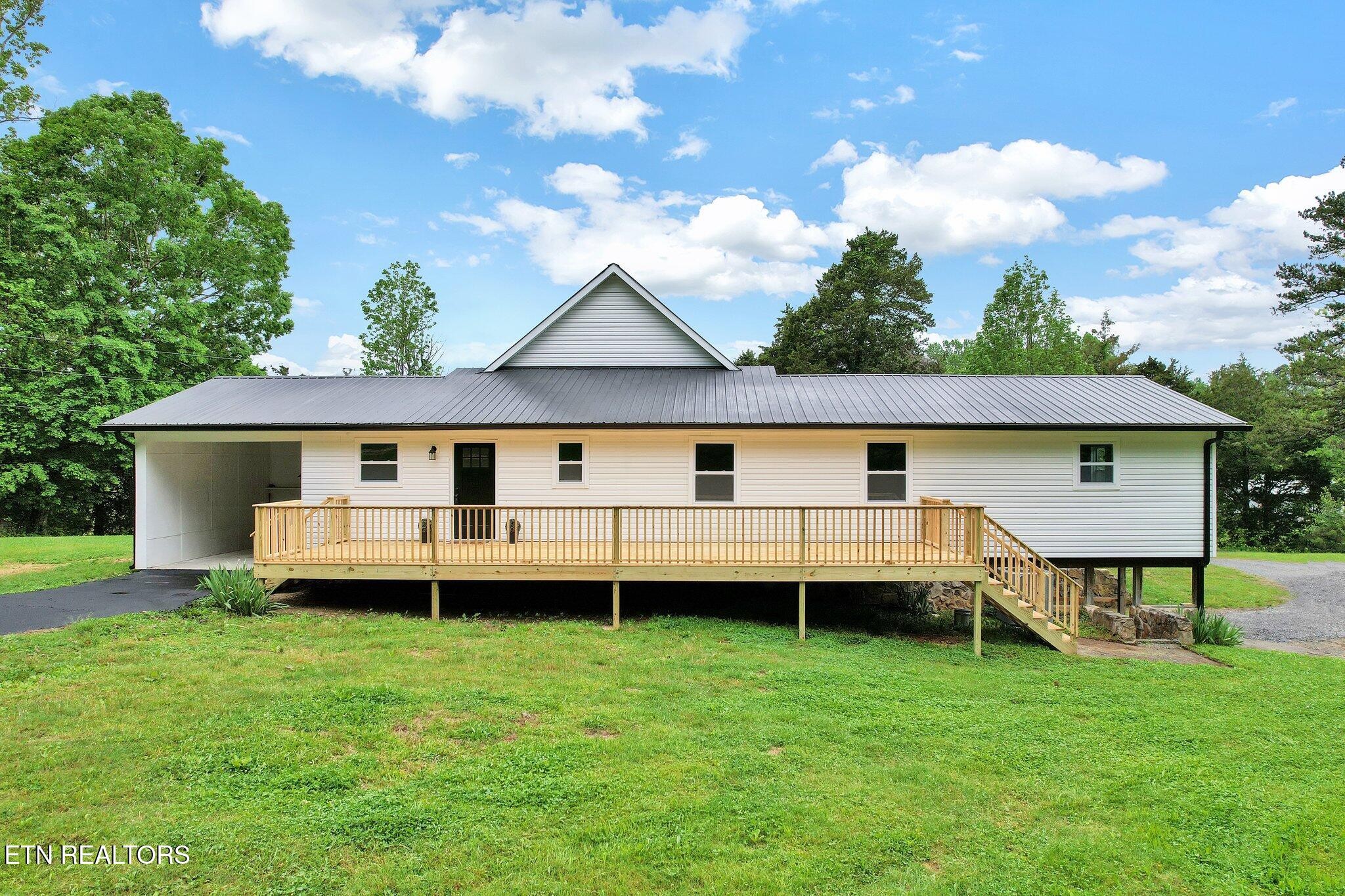 12408 North Nopone Valley Road Decatur, TN 37322 - Photo 1 of 54 a view of a house with a backyard and a garden