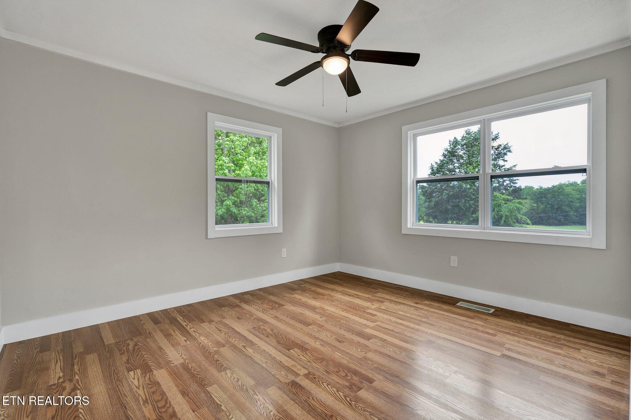 12408 North Nopone Valley Road Decatur, TN 37322 - Photo 27 of 54 a view of empty room with wooden floor and fan