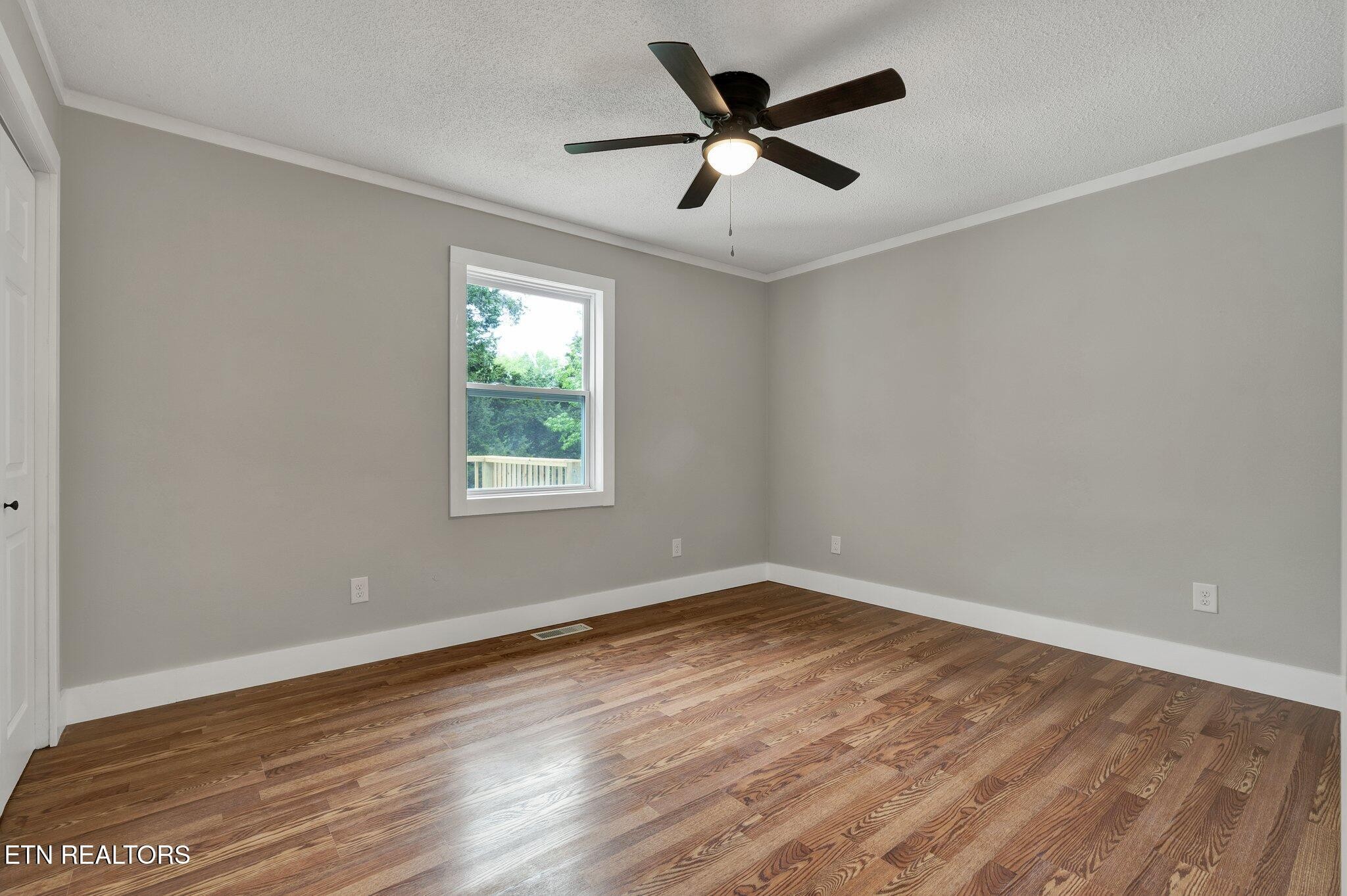 12408 North Nopone Valley Road Decatur, TN 37322 - Photo 28 of 54 a view of a big room with wooden floor and windows