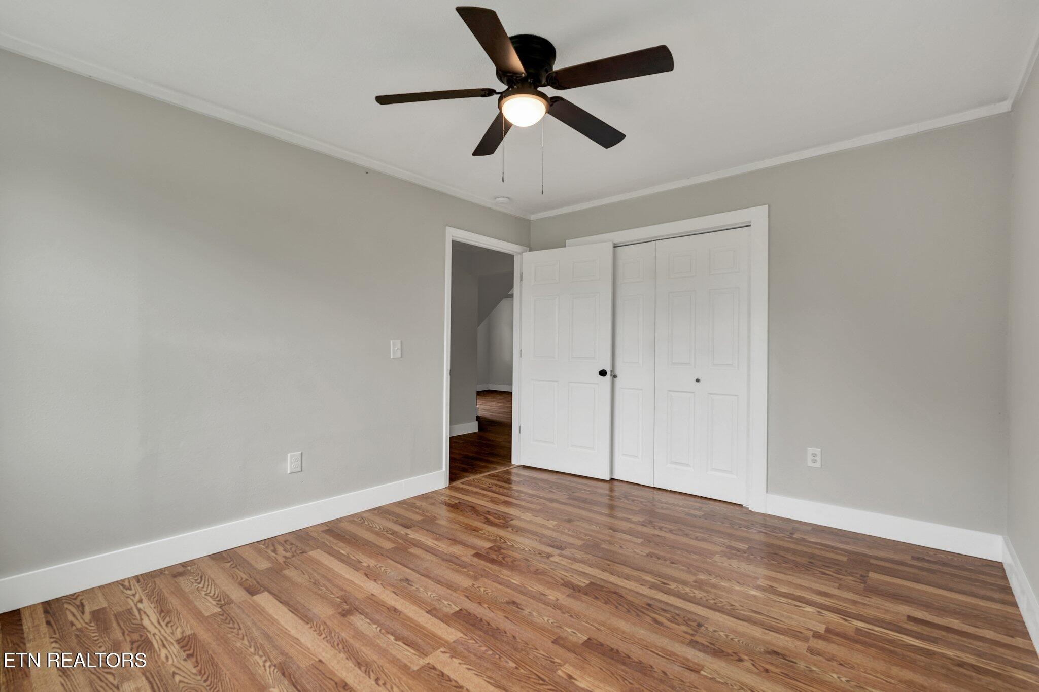 12408 North Nopone Valley Road Decatur, TN 37322 - Photo 29 of 54 a view of room with wooden floor and ceiling fan