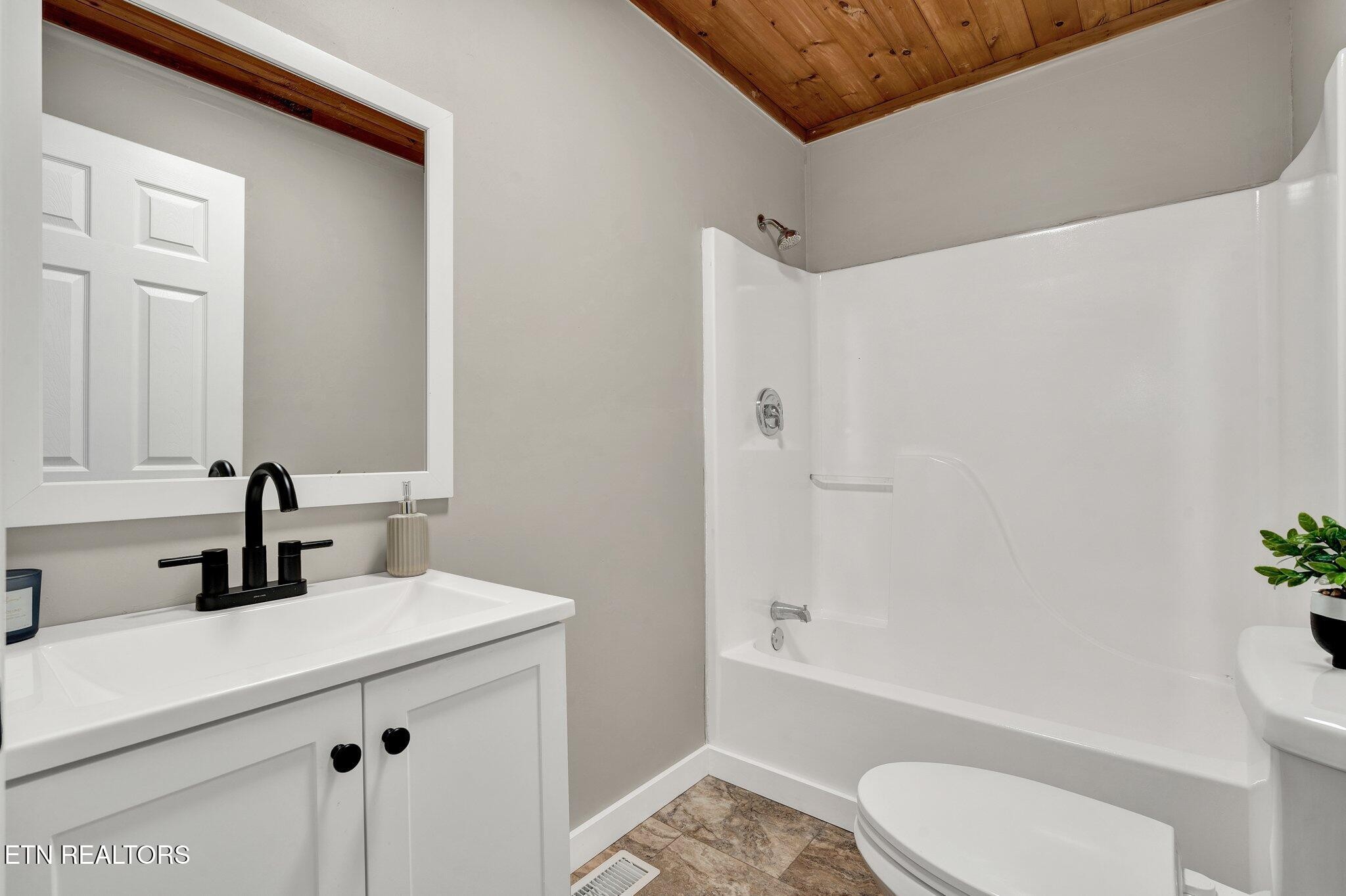 12408 North Nopone Valley Road Decatur, TN 37322 - Photo 30 of 54 a bathroom with a sink a toilet and shower