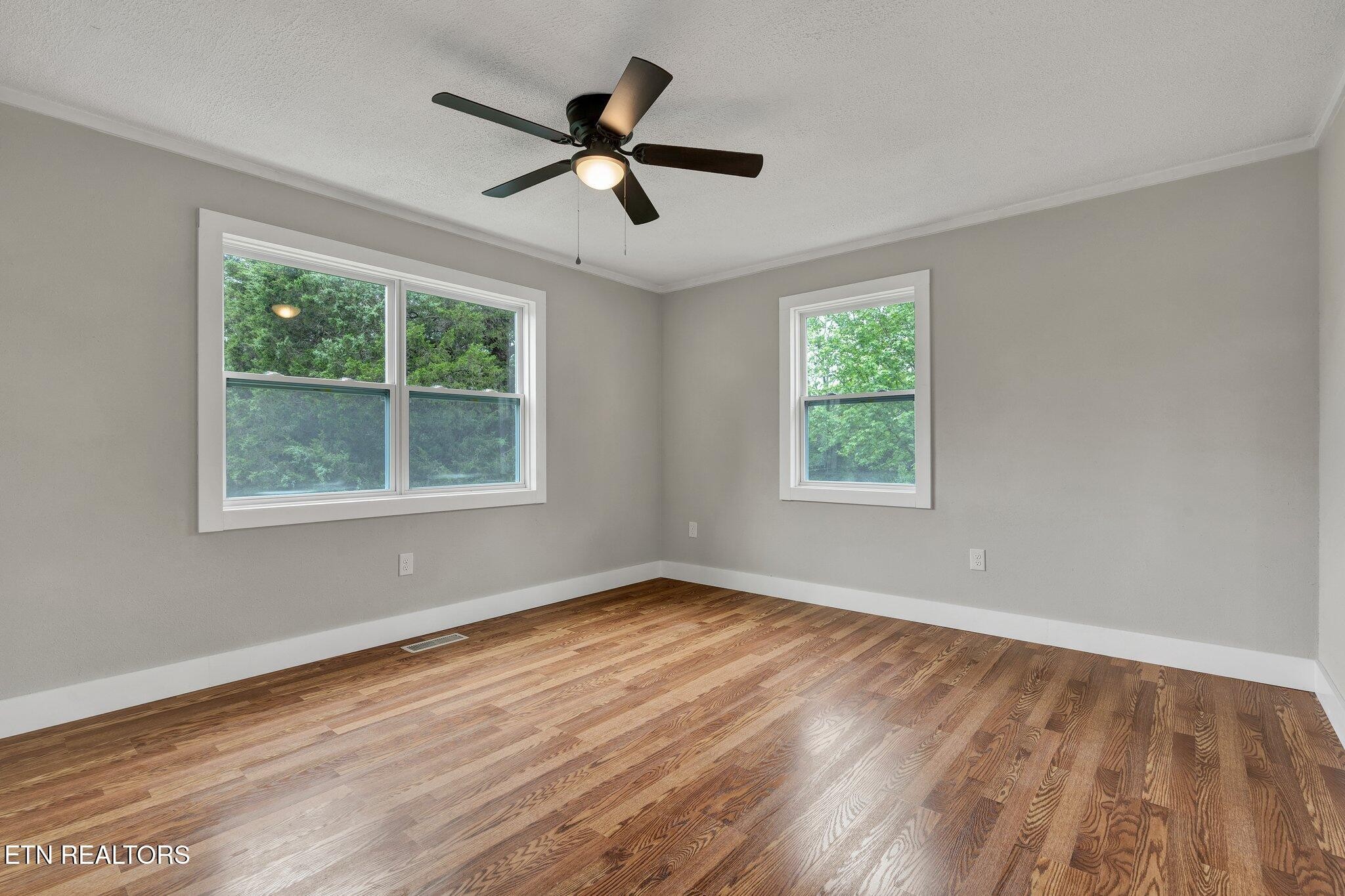 12408 North Nopone Valley Road Decatur, TN 37322 - Photo 32 of 54 a view of empty room with wooden floor and fan