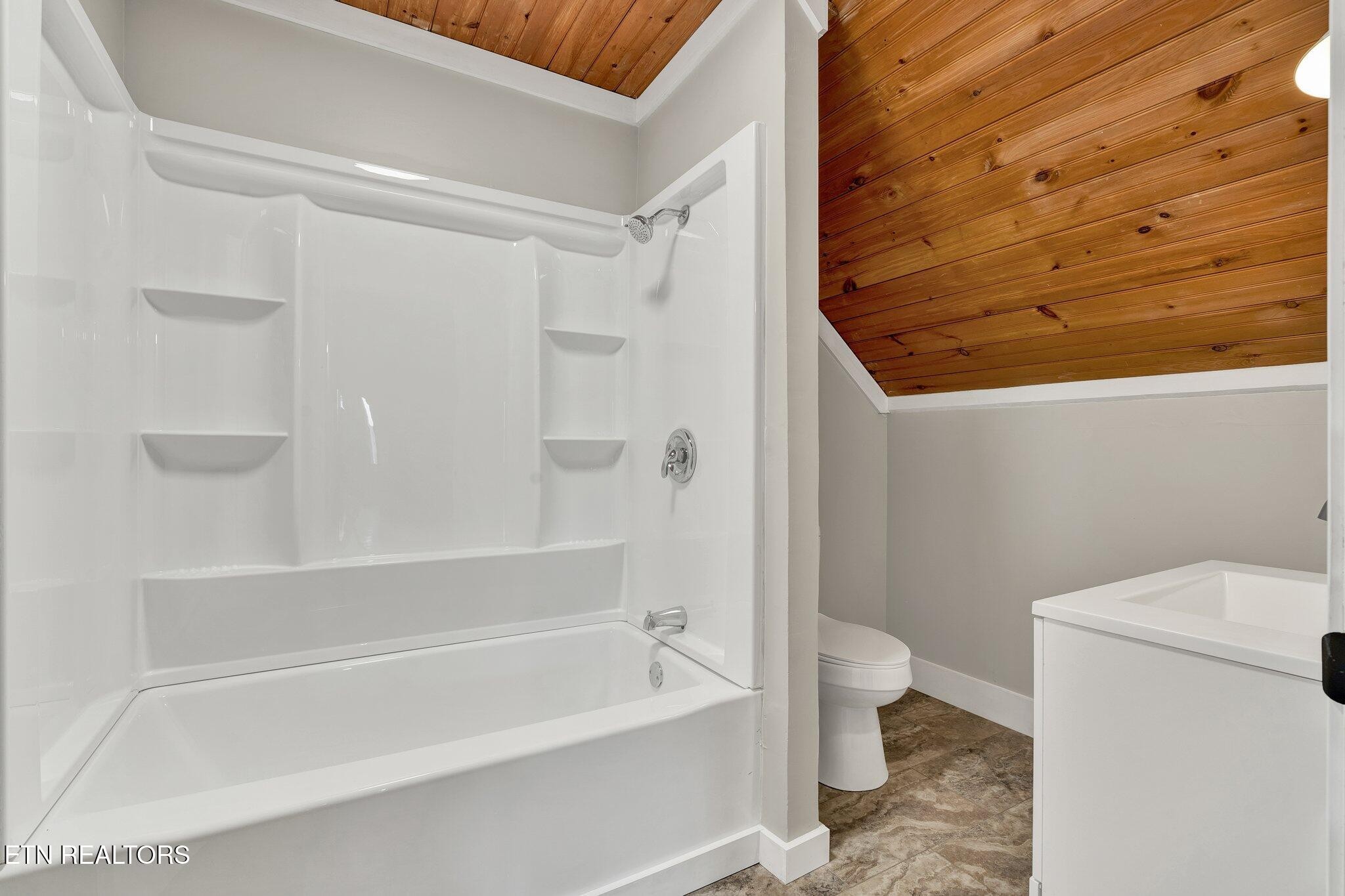 12408 North Nopone Valley Road Decatur, TN 37322 - Photo 36 of 54 a bathroom with a bathtub and a toilet