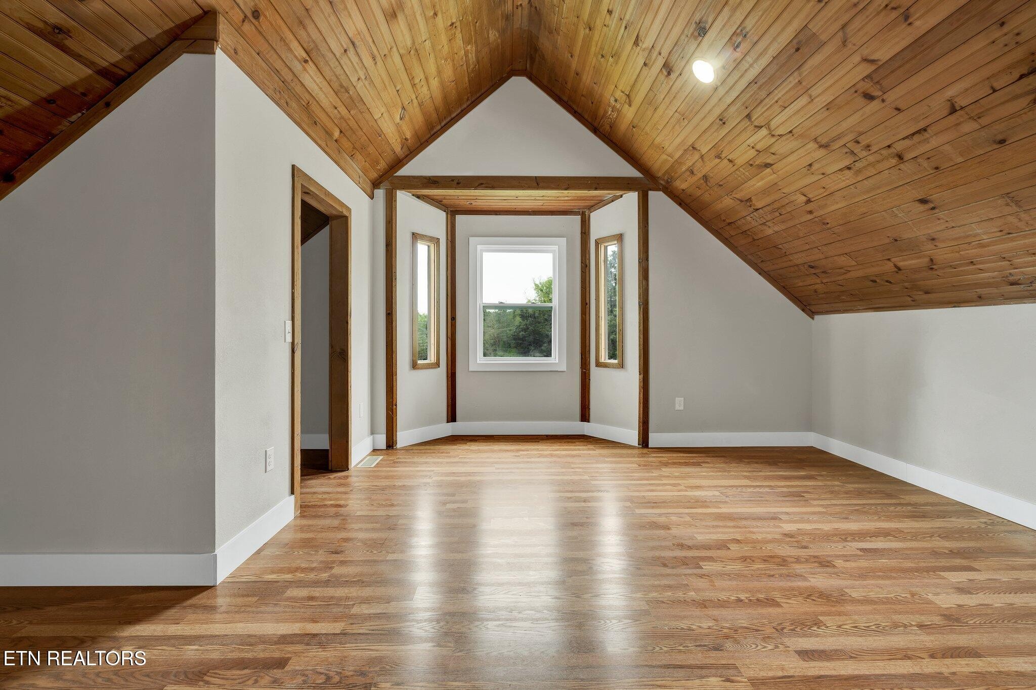 12408 North Nopone Valley Road Decatur, TN 37322 - Photo 40 of 54 a view of an empty room with wooden floor and a window