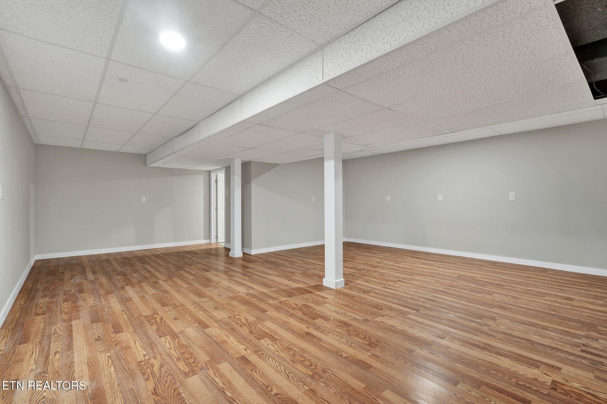 12408 North Nopone Valley Road Decatur, TN 37322 - Photo 42 of 54 a view of an empty room with wooden floor