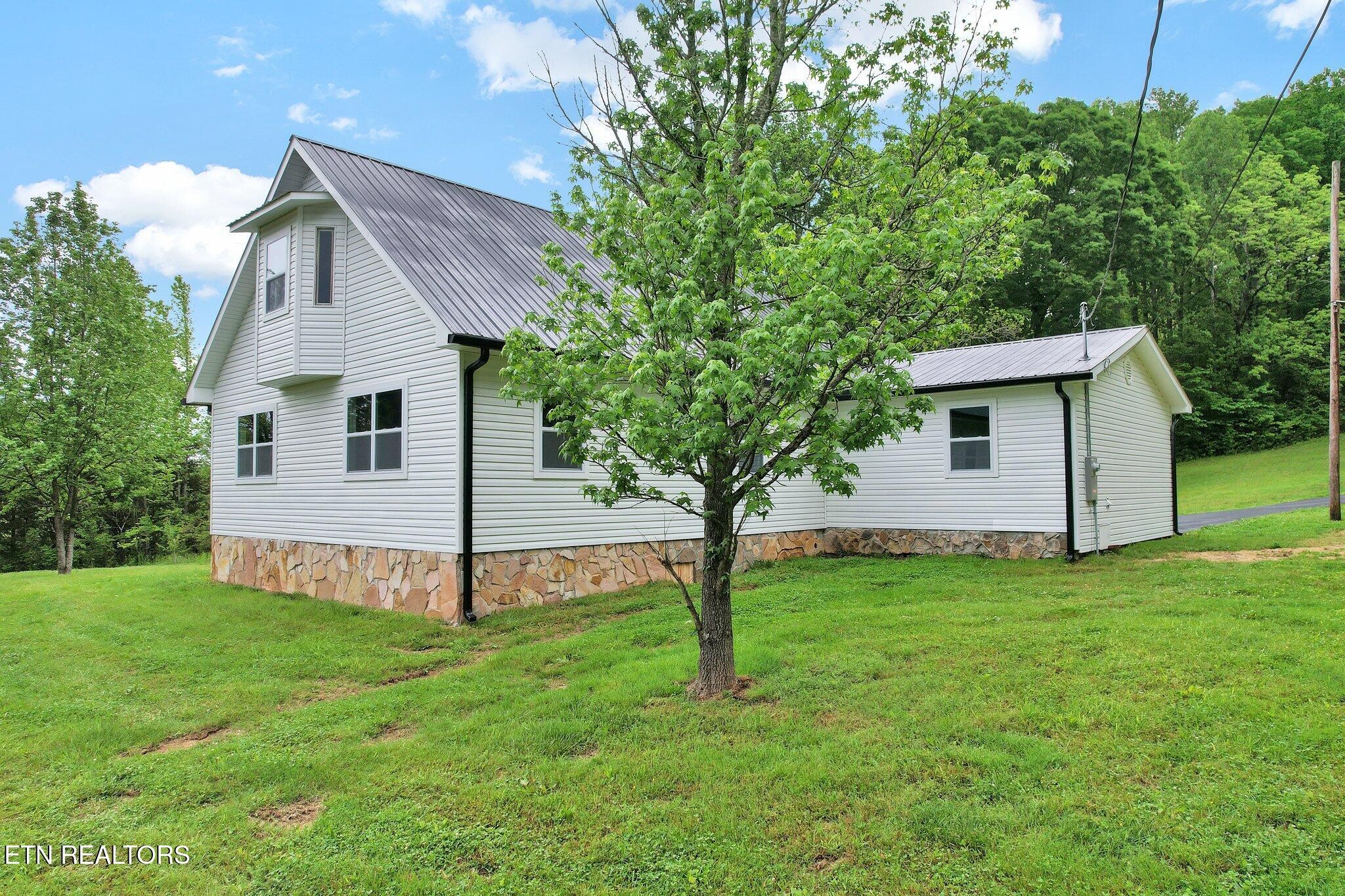 12408 North Nopone Valley Road Decatur, TN 37322 - Photo 50 of 54 a front view of a house with garden
