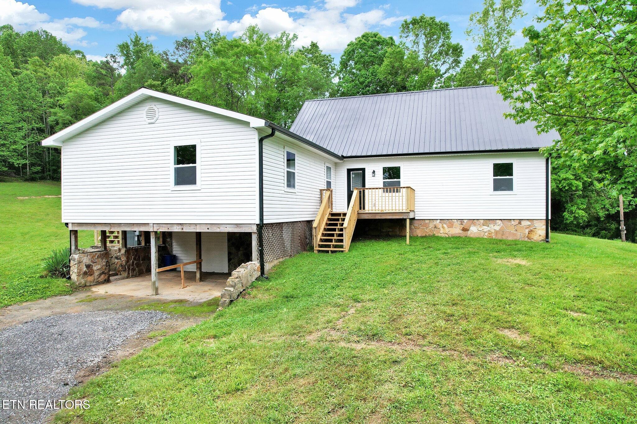12408 North Nopone Valley Road Decatur, TN 37322 - Photo 52 of 54 a view of a house with a yard and sitting area
