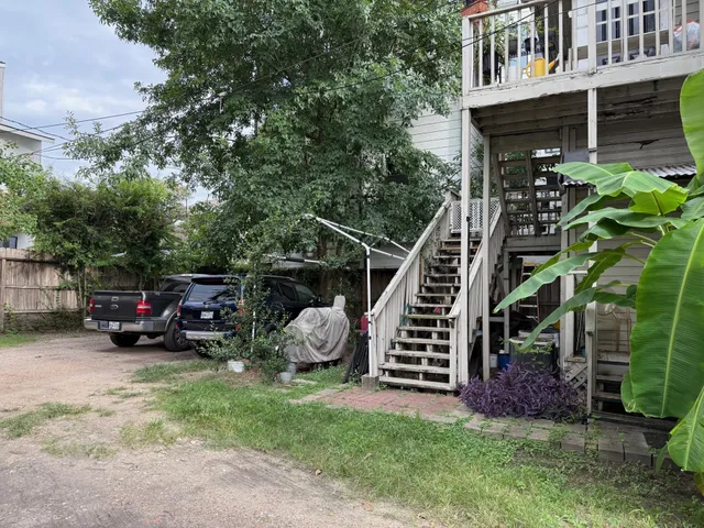 a view of a house with a yard and sitting area