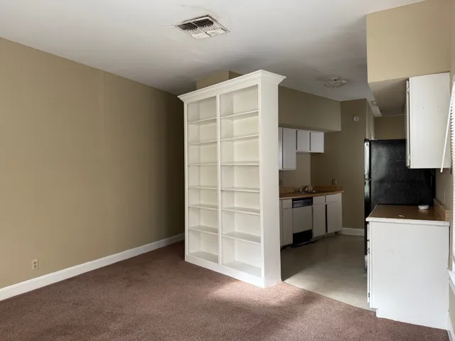 a kitchen with a refrigerator and a stove