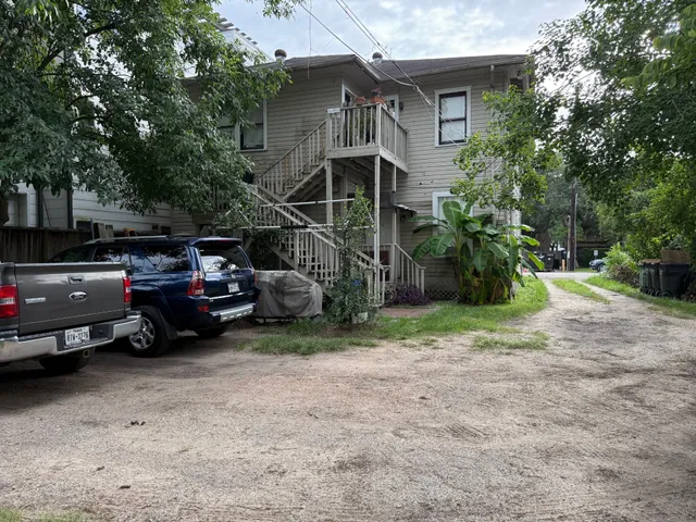 a view of a house with a car park side of a road