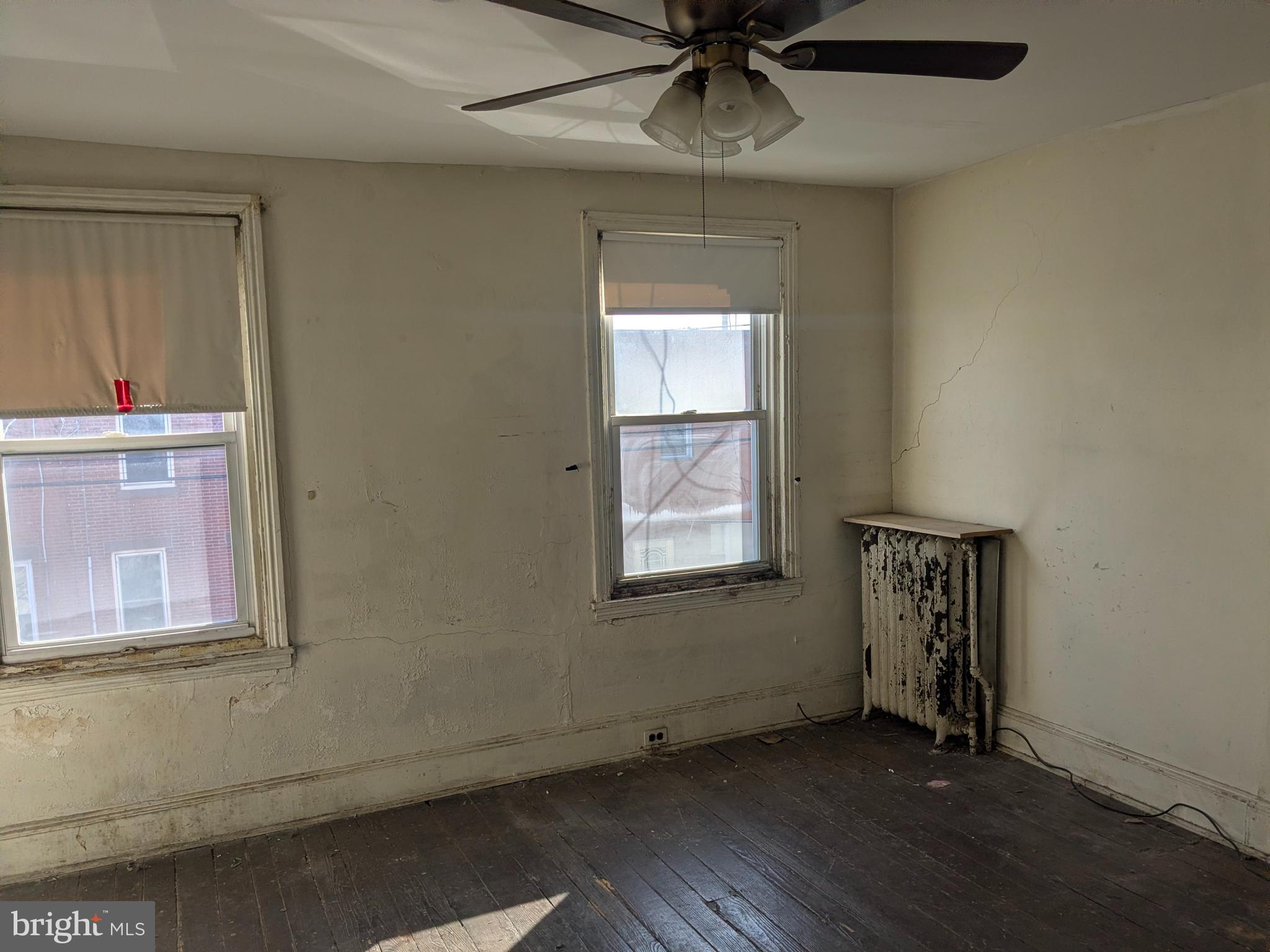 1619 Reed Street Philadelphia, PA 19146 - Photo 11 of 21 an empty room with wooden floor fan and windows
