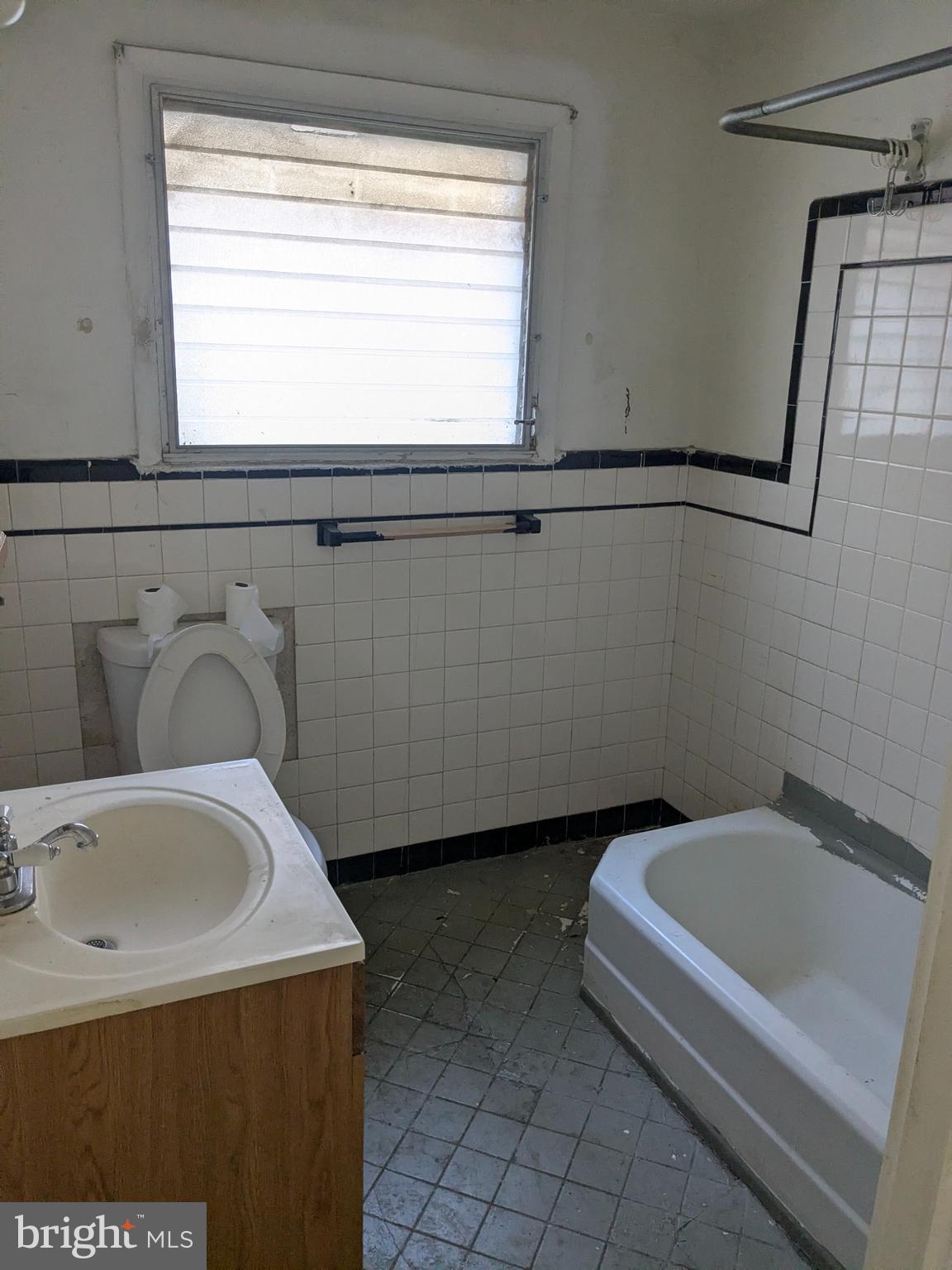 1619 Reed Street Philadelphia, PA 19146 - Photo 12 of 21 a bathroom with a sink a bathtub and a window