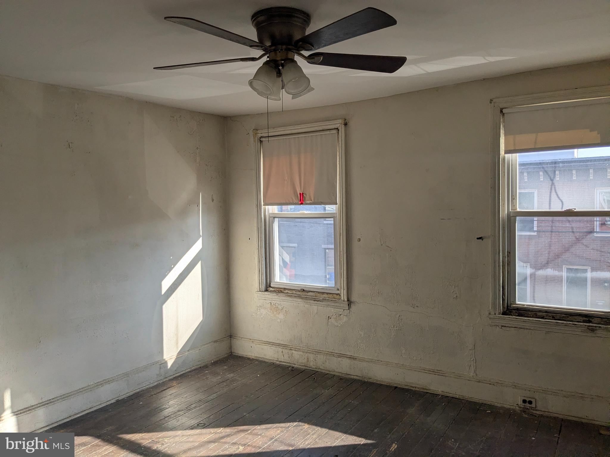 1619 Reed Street Philadelphia, PA 19146 - Photo 10 of 21 an empty room with windows and fan