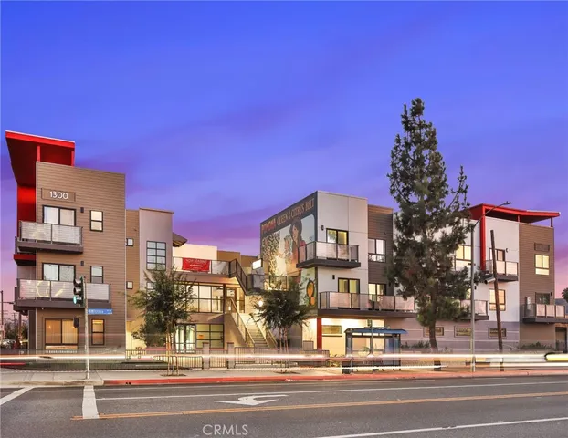 a view of a building and a cars parked