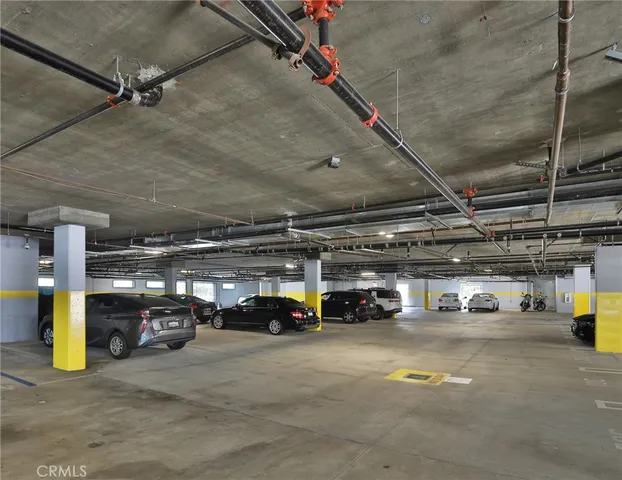 an empty room with wooden floor and cabinet