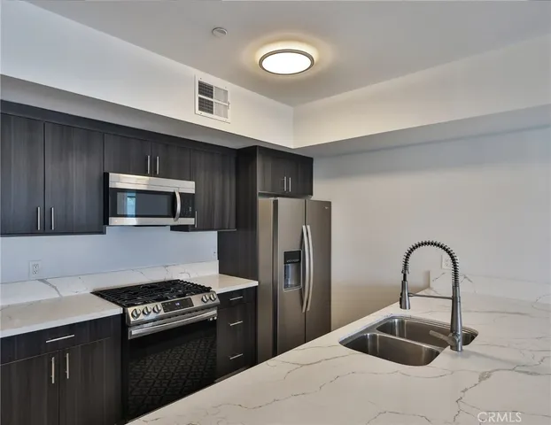 a bathroom with a granite countertop sink toilet a large mirror a vanity and shower