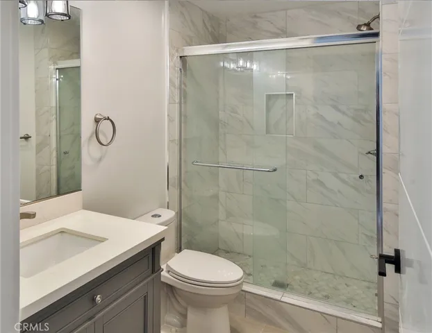 a kitchen with a refrigerator and a stove