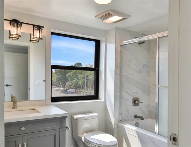 an aerial view of residential houses with city view