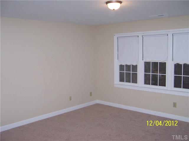 7709 Lambroll Lane Raleigh, NC 27613 - Photo 13 of 18 an empty room with a window
