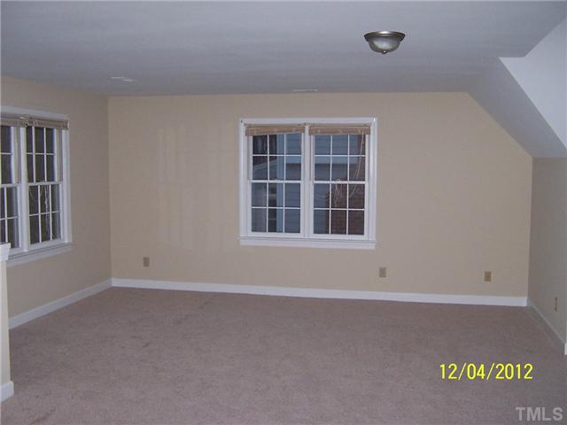 7709 Lambroll Lane Raleigh, NC 27613 - Photo 17 of 18 an empty room with windows
