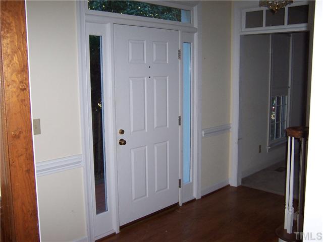 7709 Lambroll Lane Raleigh, NC 27613 - Photo 3 of 18 a view of a hallway with wooden floor