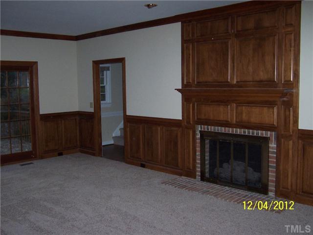 7709 Lambroll Lane Raleigh, NC 27613 - Photo 6 of 18 a living room with furniture and a fireplace