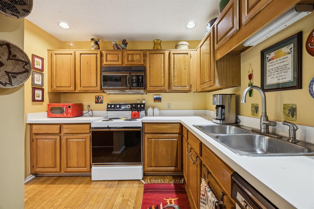 9222 Church Road, Unit 108 Dallas, TX 75231 - Photo 19 of 27 a kitchen with stainless steel appliances granite countertop a sink and cabinets