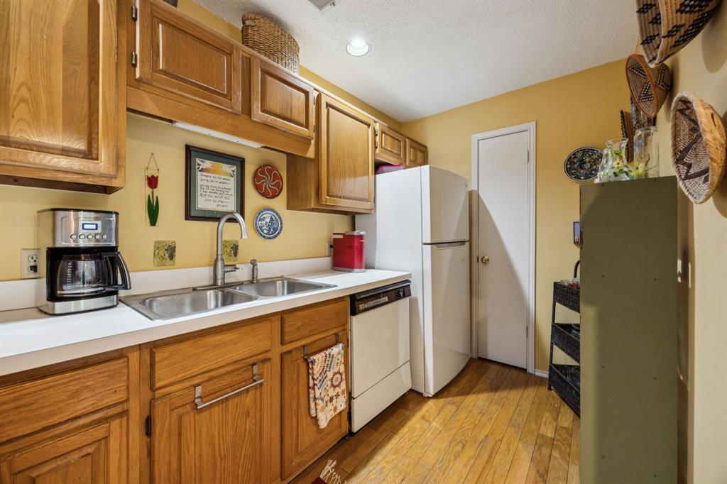 9222 Church Road, Unit 108 Dallas, TX 75231 - Photo 20 of 27 a kitchen with stainless steel appliances granite countertop a sink and cabinets