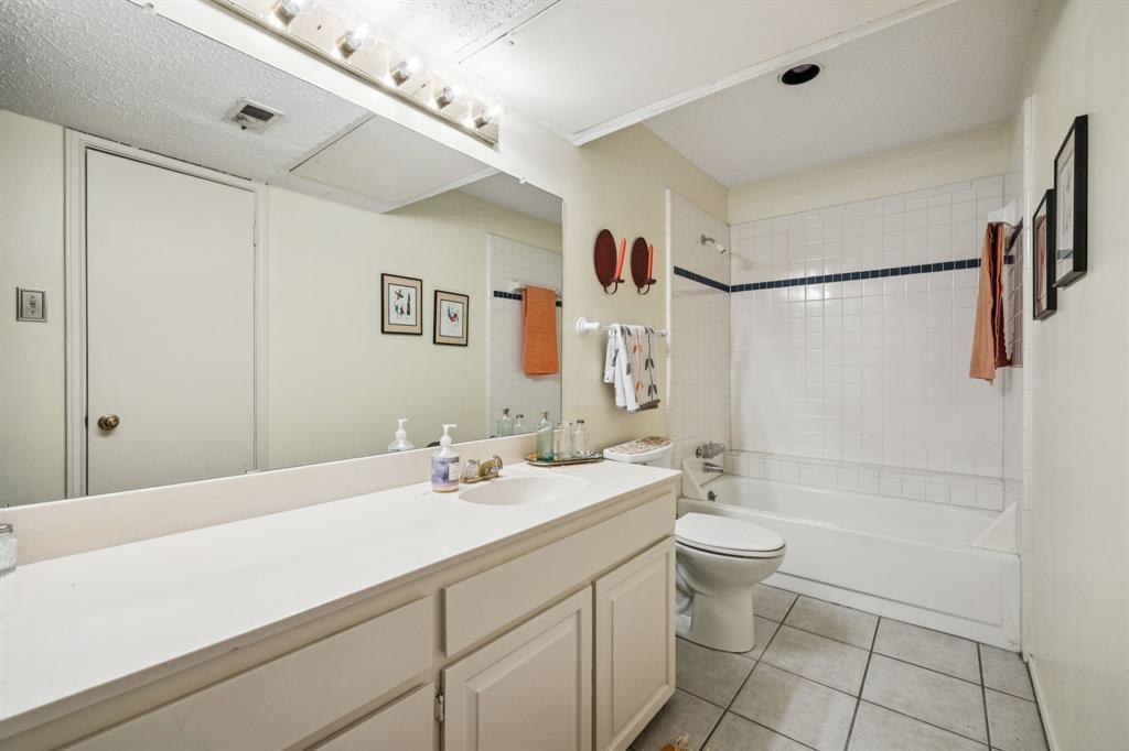 9222 Church Road, Unit 108 Dallas, TX 75231 - Photo 23 of 27 a bathroom with a sink a toilet and shower