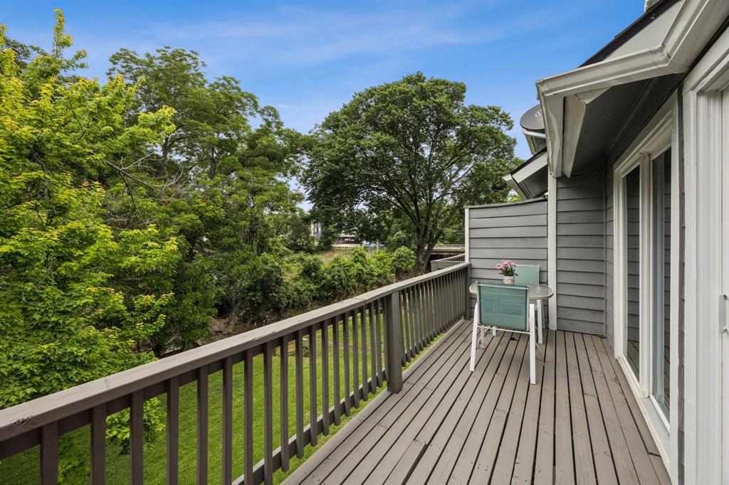 9222 Church Road, Unit 108 Dallas, TX 75231 - Photo 24 of 27 a view of balcony with wooden floor and fence