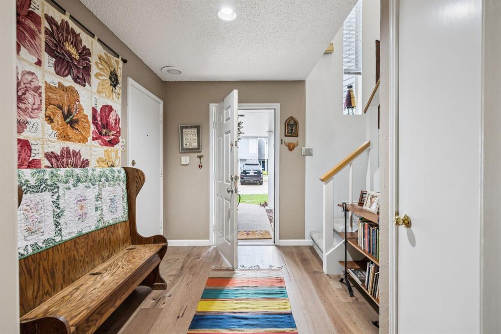 9222 Church Road, Unit 108 Dallas, TX 75231 - Photo 4 of 27 a living room with furniture and a rug