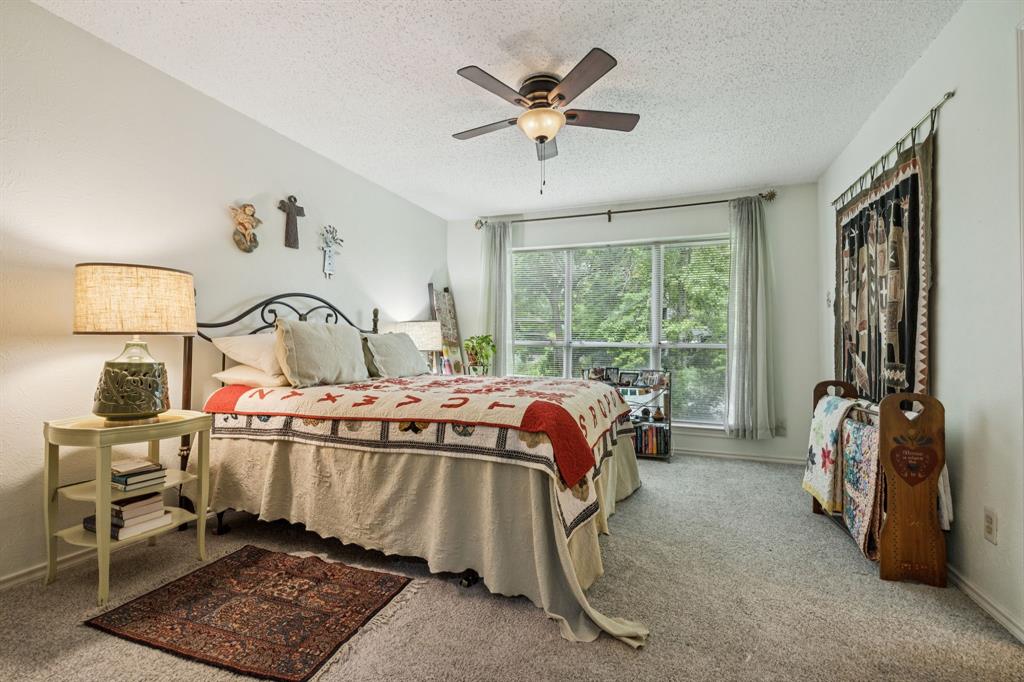 9222 Church Road, Unit 108 Dallas, TX 75231 - Photo 5 of 27 a bedroom with a bed and wooden floor