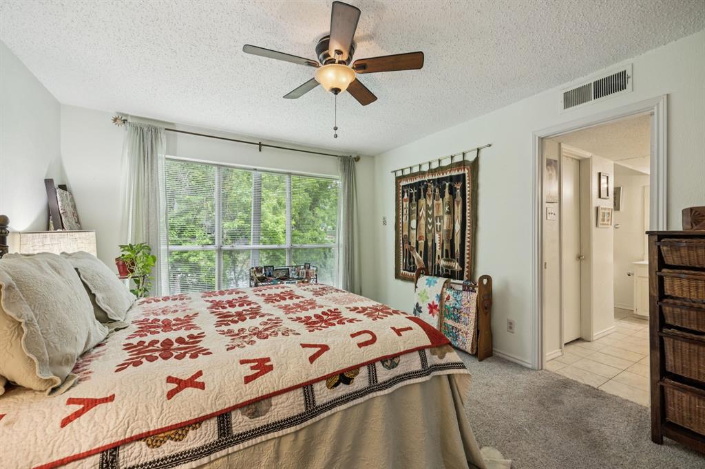 9222 Church Road, Unit 108 Dallas, TX 75231 - Photo 7 of 27 a bed sitting in a bedroom next to a window