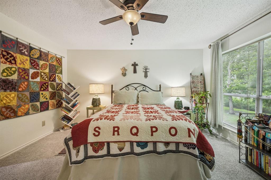 9222 Church Road, Unit 108 Dallas, TX 75231 - Photo 8 of 27 a bedroom with a bed next to a large window with the outer view