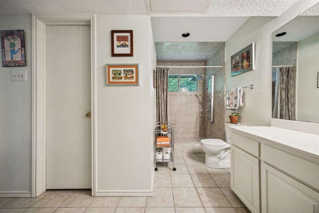 9222 Church Road, Unit 108 Dallas, TX 75231 - Photo 9 of 27 a white toilet sitting next to a bathroom sink